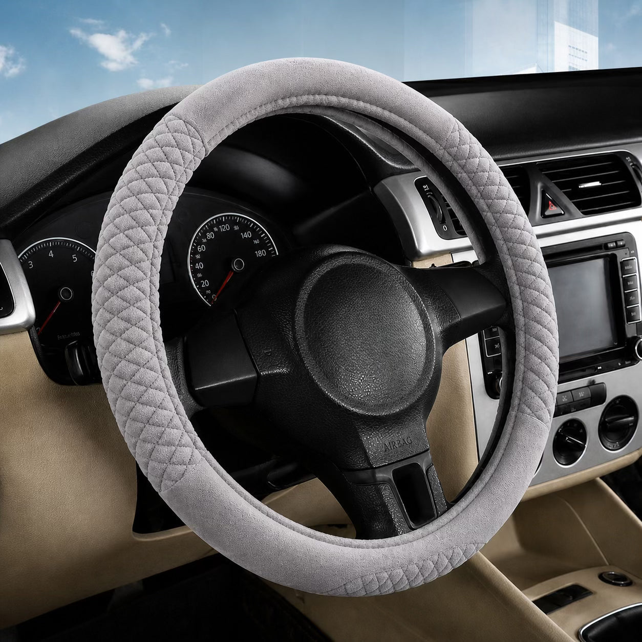 Car interior with a steering wheel cover on a vehicle dashboard.
