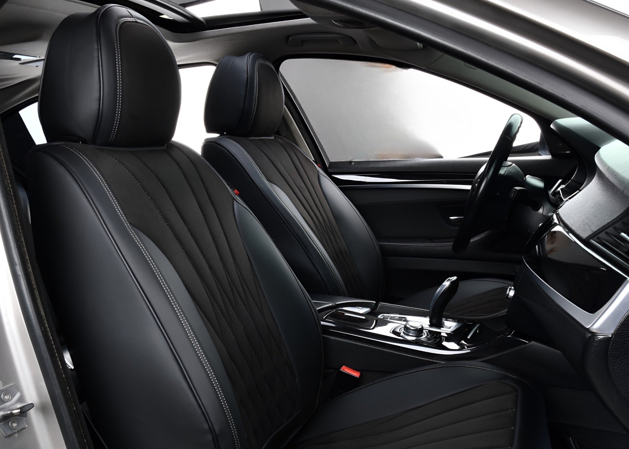 Car interior with black leather seats and dashboard.