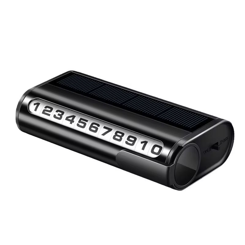 Black electronic device with solar panel and number display on a white background